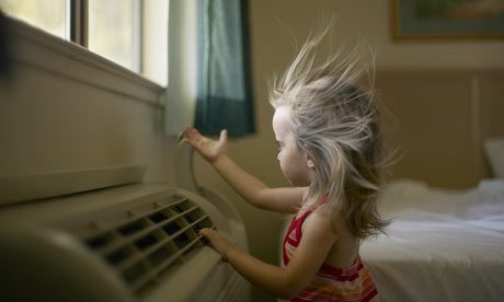 A little girl in front of an AC vent.